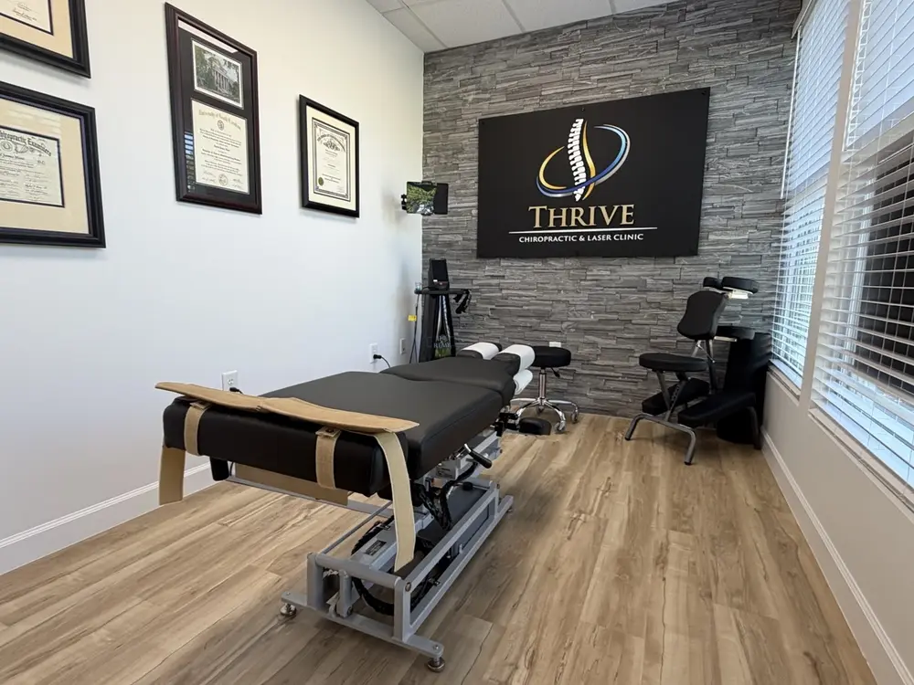 Treatment suite with adjustment table and Thrive signage